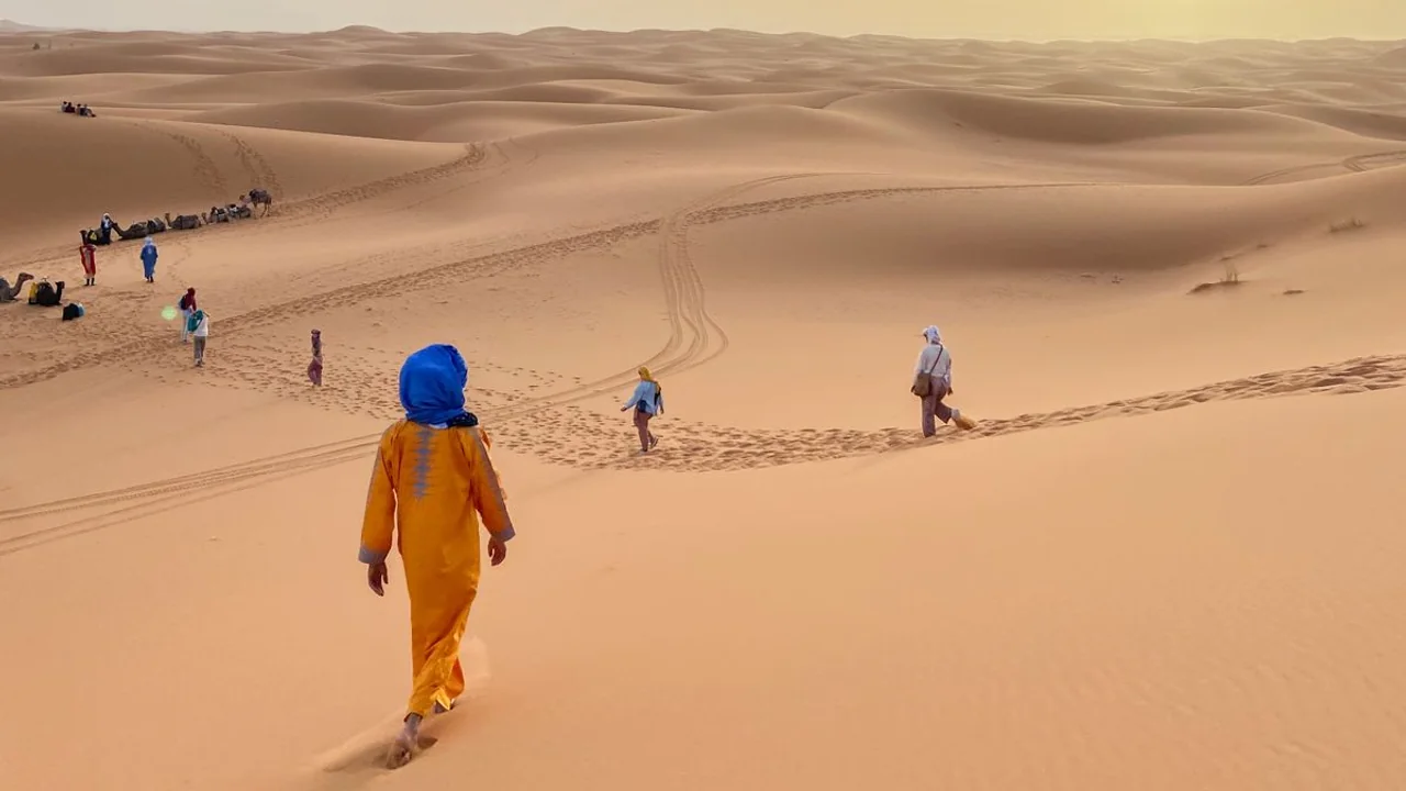 Travelers exploring the Erg Chebbi dunes in Merzouga